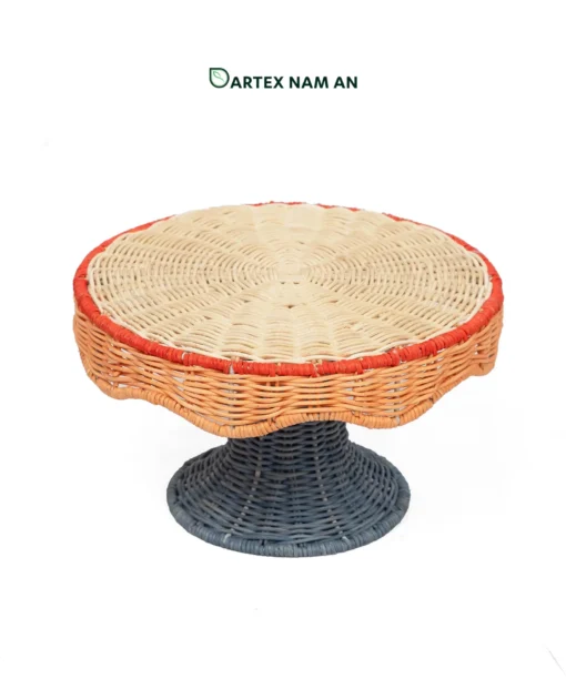 Elevate tabletop displays with our Wholesale Pedestal Tray. Handwoven from natural rattan featuring a scalloped apron, red trim accent, and dark slate grey base for HORECA buffets, corporate offices, and lifestyle retail. Bulk order ready.